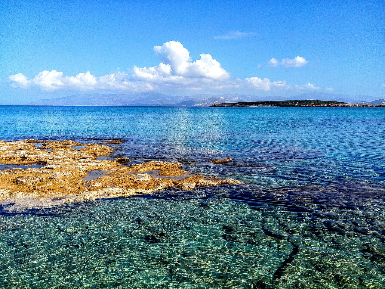 Rocky shoreline and clear blue water at Laggeri on Paros